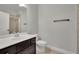 Modern bathroom featuring a shower, vanity with dark cabinets and sink, and neutral walls at 2740 Longacre Park Way, Lawrenceville, GA 30044