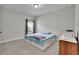 A bedroom features neutral walls, a window, and a ceiling fan at 2740 Longacre Park Way, Lawrenceville, GA 30044