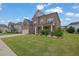 Lovely brick home showcases a lush green lawn, mature landscaping, and a welcoming facade at 2740 Longacre Park Way, Lawrenceville, GA 30044