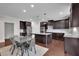 Eat-in kitchen with a granite island, modern appliances, and dark cabinetry at 2740 Longacre Park Way, Lawrenceville, GA 30044