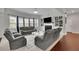 Spacious living room featuring a fireplace, custom built-ins, and hardwood floors at 2740 Longacre Park Way, Lawrenceville, GA 30044