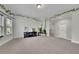 Large living room with neutral walls and carpeting, a black media center, and lots of natural light at 2740 Longacre Park Way, Lawrenceville, GA 30044