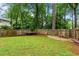 Large, fenced backyard with plenty of space for recreation and relaxation, featuring mature trees at 490 Hunters Glen Ct, Lawrenceville, GA 30044