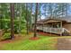 Backyard view showing the deck, mature trees, and lush greenery at 490 Hunters Glen Ct, Lawrenceville, GA 30044