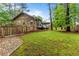 View of the backyard with wood fence, showcasing ample green space and privacy at 490 Hunters Glen Ct, Lawrenceville, GA 30044