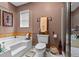 Well-lit bathroom featuring a tub, separate shower, toilet, and window at 490 Hunters Glen Ct, Lawrenceville, GA 30044