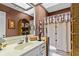 Unique bathroom with a skylight, vanity, decorative mirror, and stylish shower curtain at 490 Hunters Glen Ct, Lawrenceville, GA 30044