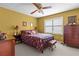 Bedroom featuring a comfortable bed, ceiling fan, window, and traditional furniture at 490 Hunters Glen Ct, Lawrenceville, GA 30044