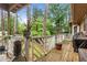 View of back deck with trees, plants, and a grill at 490 Hunters Glen Ct, Lawrenceville, GA 30044