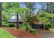 Charming home featuring wood siding, well-manicured landscaping, and an attached two-car garage at 490 Hunters Glen Ct, Lawrenceville, GA 30044