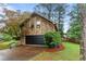 Side view of home showcasing an attached garage and unique wood siding at 490 Hunters Glen Ct, Lawrenceville, GA 30044