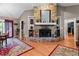 Cozy living room features a stunning stone fireplace and mantle for displaying decor at 490 Hunters Glen Ct, Lawrenceville, GA 30044