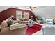 Cozy living room featuring neutral toned sofas, glass table, and a red carpet at 490 Hunters Glen Ct, Lawrenceville, GA 30044