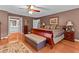 Elegant main bedroom with hardwood floors, decorative rug, and a glimpse of a stylish bathroom at 490 Hunters Glen Ct, Lawrenceville, GA 30044