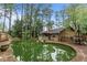 Backyard pool surrounded by mature landscaping and home at 490 Hunters Glen Ct, Lawrenceville, GA 30044