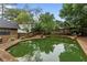 Backyard pool surrounded by mature landscaping and wooden fence at 490 Hunters Glen Ct, Lawrenceville, GA 30044