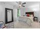 Bright bedroom featuring a large mirror, comfortable bed, and natural light filtering through the windows at 1346 Peter Haughton Nw Way # 2, Atlanta, GA 30318