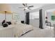 Spacious bedroom with a ceiling fan, large window, and stylish decor provides a relaxing and inviting atmosphere at 1346 Peter Haughton Nw Way # 2, Atlanta, GA 30318