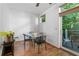 Cozy dining area featuring modern table set, hardwood flooring, and access to outdoor patio space at 1346 Peter Haughton Nw Way # 2, Atlanta, GA 30318