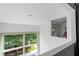 Bright interior view with large windows showcasing the surrounding lush greenery and natural light at 1346 Peter Haughton Nw Way # 2, Atlanta, GA 30318