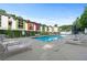 Community swimming pool with colorful buildings in the background and ample lounging space at 1346 Peter Haughton Nw Way # 2, Atlanta, GA 30318