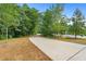 Curving sidewalk with yellow dividing line flanked by lush green trees at 1346 Peter Haughton Nw Way # 2, Atlanta, GA 30318