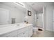 Well-lit bathroom with a vanity, frameless shower, and neutral tile at 207 Harmony Lake Dr, Canton, GA 30115