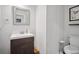 Bathroom featuring dark wood vanity with white sink, modern fixtures, and toilet at 207 Harmony Lake Dr, Canton, GA 30115