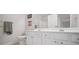Bright bathroom featuring a shower, toilet, and white cabinets with an expansive countertop and a large mirror at 207 Harmony Lake Dr, Canton, GA 30115