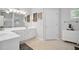 Bathroom boasts white cabinets, a wide mirror, and a window for natural light at 207 Harmony Lake Dr, Canton, GA 30115