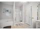 Bright bathroom featuring a shower, tub, and a large vanity area at 207 Harmony Lake Dr, Canton, GA 30115