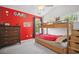 Colorful bedroom with a bunk bed and red accent wall at 207 Harmony Lake Dr, Canton, GA 30115