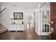 Bright foyer featuring hardwood floors, staircase, and stylish decor at 207 Harmony Lake Dr, Canton, GA 30115