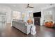 Cozy living room with fireplace, ceiling fan, and seamless flow to the dining area at 207 Harmony Lake Dr, Canton, GA 30115