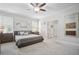 Bright main bedroom featuring plush carpet, king bed, and side tables, offering a relaxing retreat at 207 Harmony Lake Dr, Canton, GA 30115