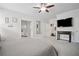 Spacious main bedroom with ensuite bath, TV, ceiling fan and neutral color palette at 207 Harmony Lake Dr, Canton, GA 30115