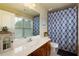 Well-lit bathroom with a stylish vanity, a large mirror, and a shower with patterned curtains at 2107 Se Gorman Se Grv # 132, Atlanta, GA 30316