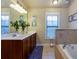 Bright bathroom with double vanity, a large mirror, a soaking tub, and abundant natural light at 2107 Se Gorman Se Grv # 132, Atlanta, GA 30316