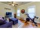 Comfortable living room with hardwood floors, a couch, a TV, and plenty of natural light at 2107 Se Gorman Se Grv # 132, Atlanta, GA 30316