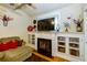 Bright living room with fireplace, television, and built-in shelving for decor at 2107 Se Gorman Se Grv # 132, Atlanta, GA 30316