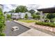 Inviting community space with manicured lawn, seating, and charming white townhomes at 24 Becker Nw Pl, Atlanta, GA 30307
