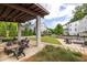 Community outdoor lounge area featuring seating, picnic table, and grill, surrounded by green space and trees at 24 Becker Nw Pl, Atlanta, GA 30307