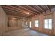 Unfinished basement with exposed ceiling, studded walls, and natural light at 6861 Ga Hwy 5, Douglasville, GA 30135