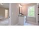 Bathroom featuring granite vanity, marble tile, and a bright window view at 6861 Ga Hwy 5, Douglasville, GA 30135