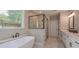 Luxurious bathroom featuring a soaking tub and walk-in shower with tiled walls at 6861 Ga Hwy 5, Douglasville, GA 30135