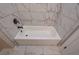 Bathroom with white marble tiling and white bathtub at 6861 Ga Hwy 5, Douglasville, GA 30135