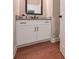 Bathroom vanity with granite countertops, white cabinets, and hardwood floors at 6861 Ga Hwy 5, Douglasville, GA 30135