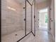Luxurious glass enclosed walk-in shower featuring beige tile, a bench, and tile flooring at 6861 Ga Hwy 5, Douglasville, GA 30135
