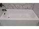 Close up of bathtub with marble tile surround at 6861 Ga Hwy 5, Douglasville, GA 30135