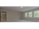 A bright bedroom with plush carpet and a wall of windows overlooking a wooded area at 6861 Ga Hwy 5, Douglasville, GA 30135